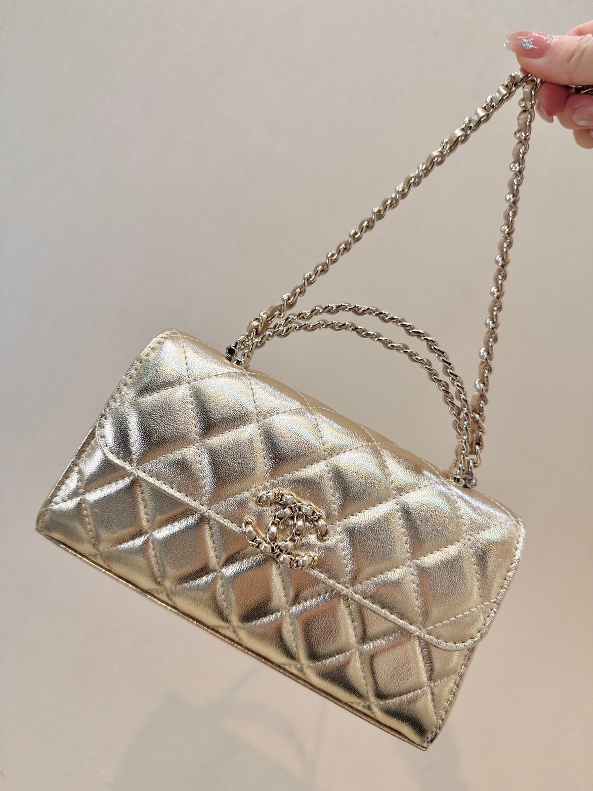 Chanel Clutch on Chain with Top Handle  in Champagne Gold front view 2