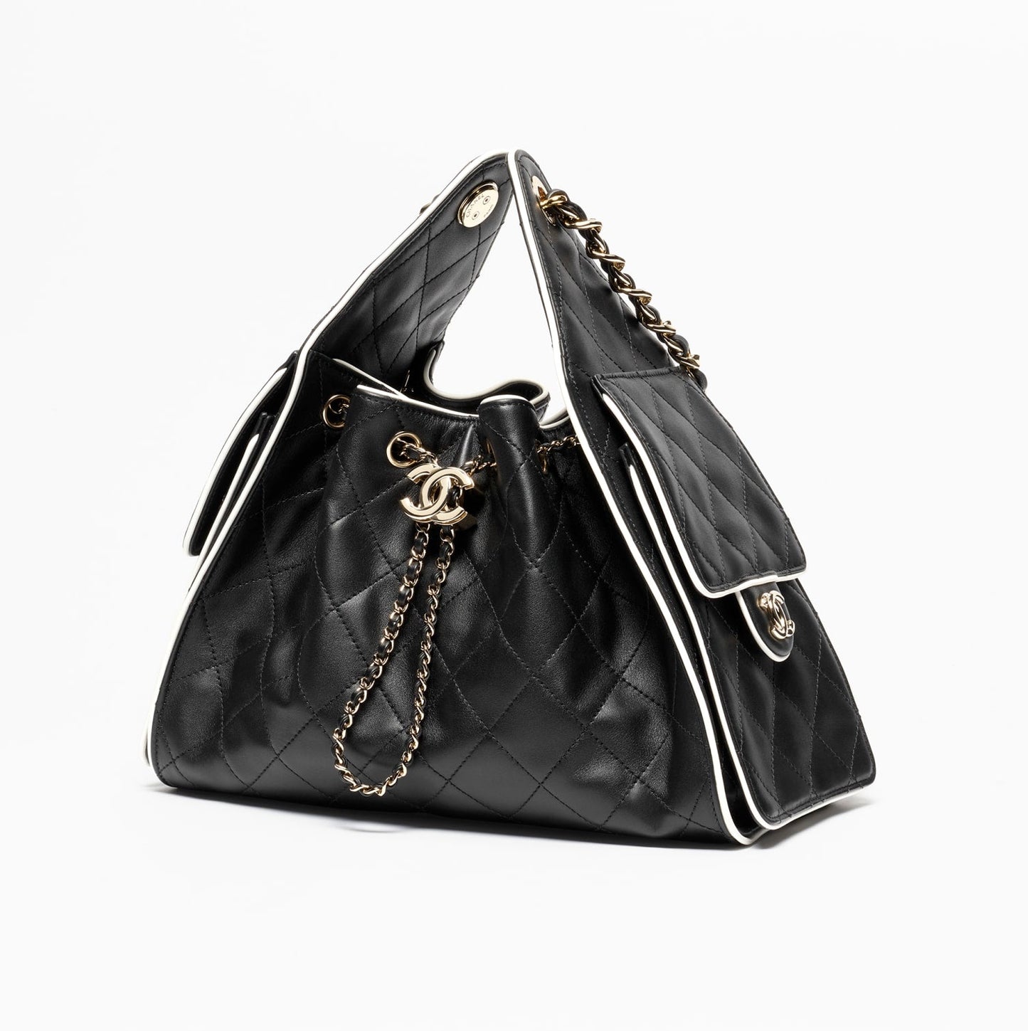 Black quilted handbag with gold chain detail on a white background